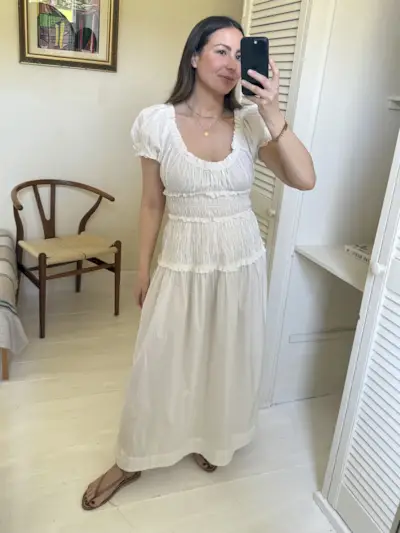 Emily wears white ruched maxi dress with sandals
