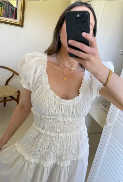 Emily wears white ruched maxi dress with sandals