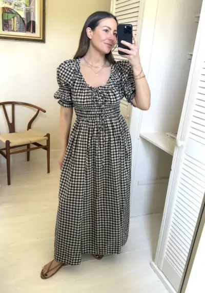 Woman wears gingham dress in mirror