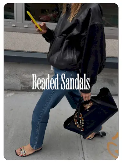 A photo of Courtney Grow wearing a leather jacket, jeans, and beaded sandals.