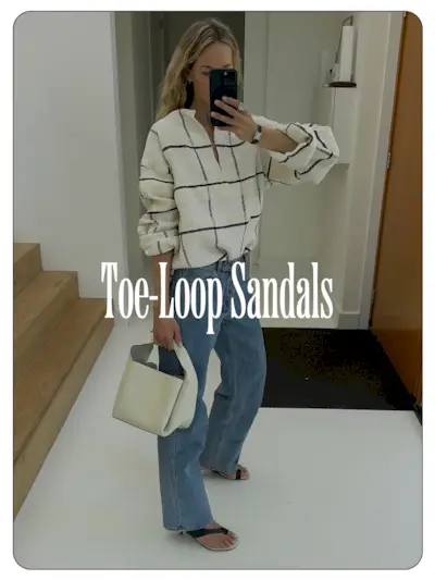 A photo of Anouk Yve wearing a plaid shirt, jeans, and toe-loop sandals.