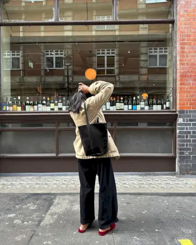 Monikh Dale carrying a black suede tote bag from The Row