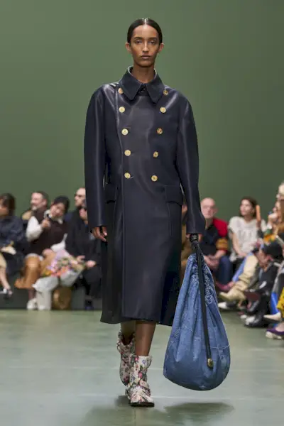 Loewe model carrying a slouchy handbag on the runway
