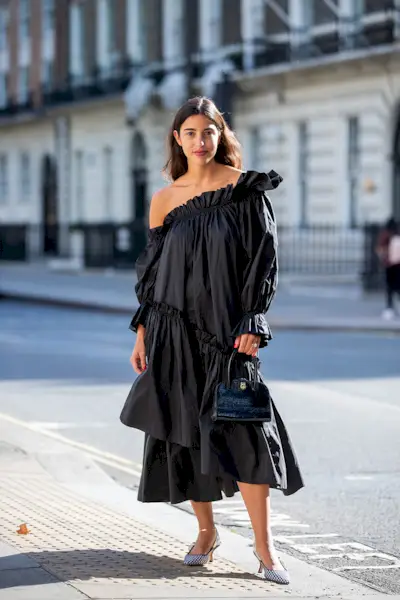 Woman wearing a midi dress and heels.