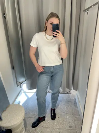 Woman wears white t-shirt and blue jeans