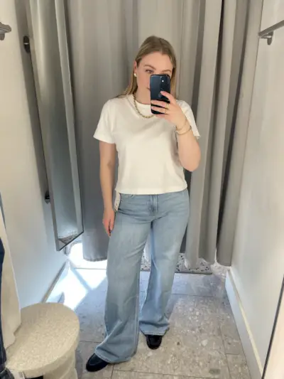 Woman wears white t-shirt and blue jeans