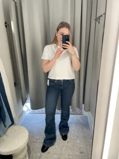 Woman wears white t-shirt and blue jeans