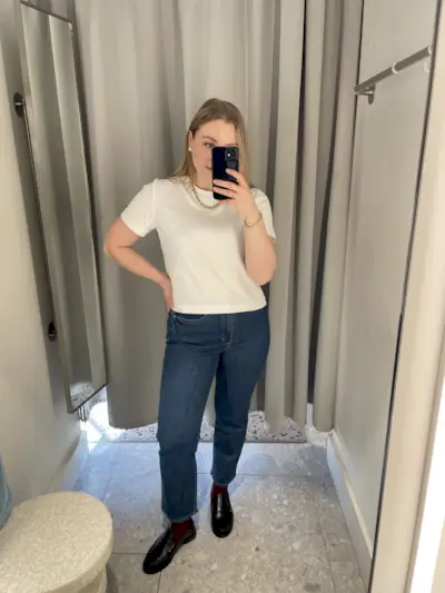 Woman wears white tee and blue jeans
