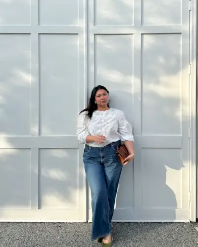 Woman wears pretty summer blouse with jeans