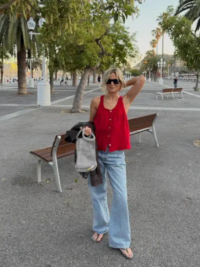 woman wears pretty summer blouse with jeans