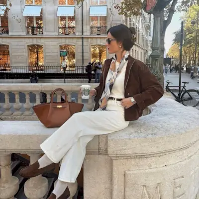 A woman sips coffee outside in France