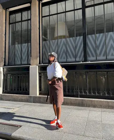Aude wearing red Nike Cortez and brown midi skirt