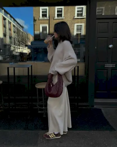 Francesca in cream knit, white slip skirt, and Adidas SL72 trainers