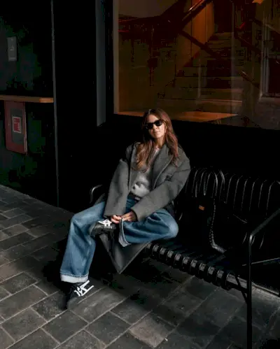 Kim wearing jeans, grey blazer coat, and Onitsuka Tiger Mexico 66 Sneakers