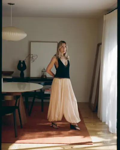 An image of @angelafink wearing balloon trousers with a tank top and wedge heels, an example of what to wear instead of skinny jeans.