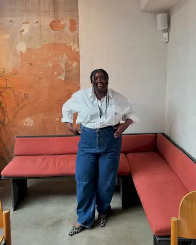 An image of @abimarvel wearing straight-leg jeans with Gucci slingback heels and a white Calvin Klein button-down, an example of what to wear instead of skinny jeans.