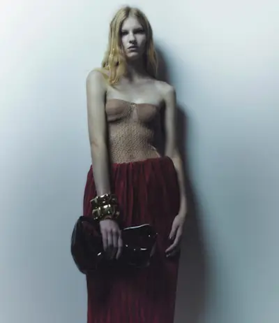 Woman holding a quiet luxury handbag from Khaite.