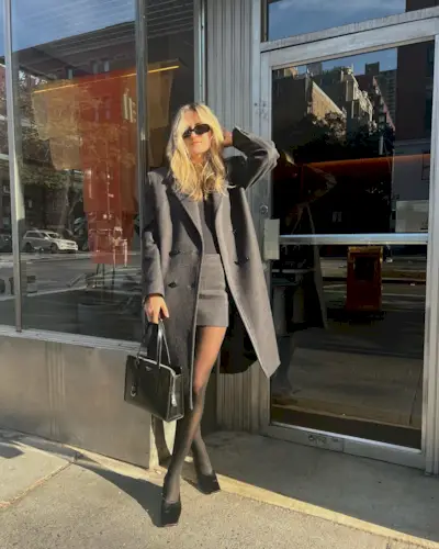 Woman holding a quiet luxury handbag from Prada.