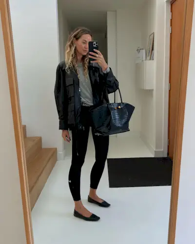 Fashion influencer @anoukyve wears a chic outfit with basic black leggings.