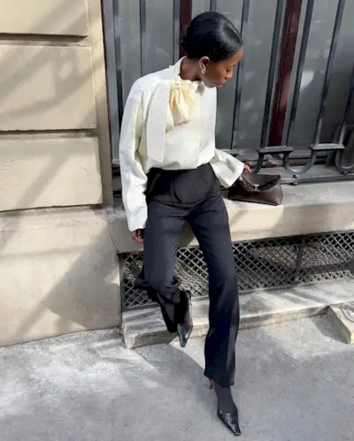 An image of @sylviemus_ wearing a scarf blouse from Rohé, one of the key luxury independent fashion brands