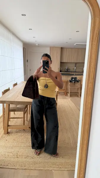 An image of @monikh wearing a bandeau top from Tove, one of the best luxury independent fashion brands.