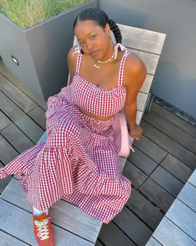 Influencer in red gingham two piece set and orange, pink and red adidas trainers.