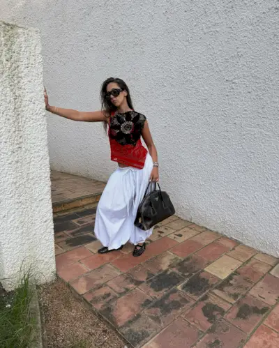 Hanna MW wearing a crochet top and white bubble pants.