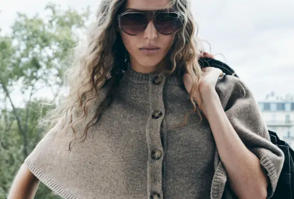 Woman in cape sweater.