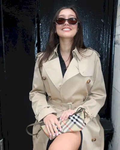 Hailey Sani wearing a tan trench coat.