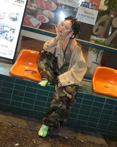 Jess Xu wearing camo pants and green Puma sneakers.