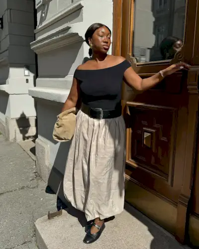 Summer Outfit Ideas 2025: @nnennaechem wears a beige bubble hem skirt with a black off-the-shoulder top