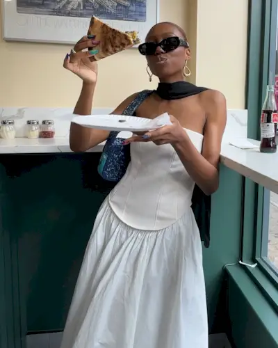 Summer Outfit Ideas 2025: @chanelmckinsie wears a white strapless dress and neck scarf