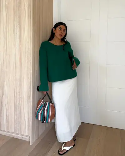 Summer Outfit Ideas 2025: @monikh wears a white linen skirt with white sandals and a green jumper