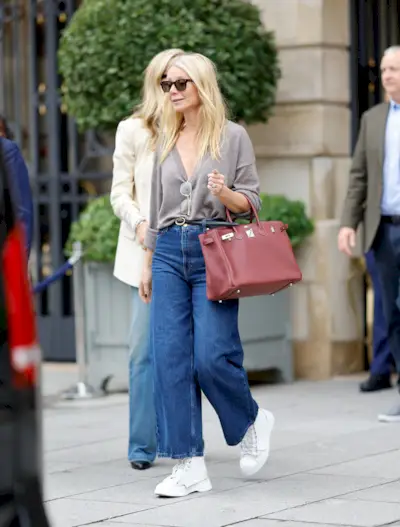 Woman wearing burgundy bag.