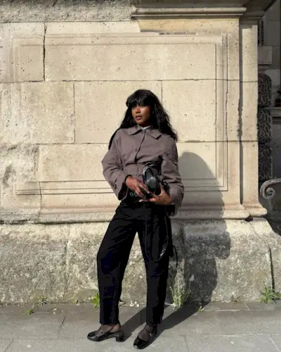 Andi mun wears tailored trousers