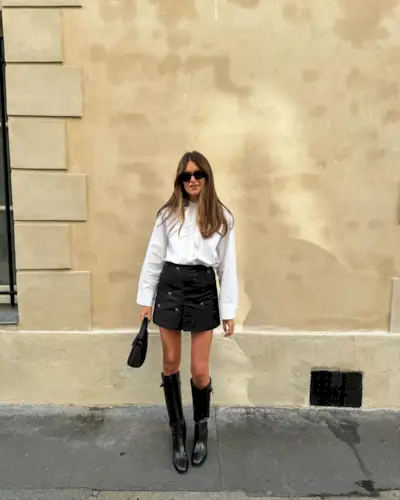 Sara in a white blouse and skirt