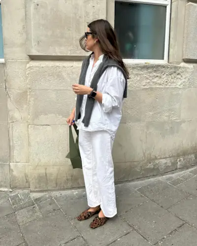 Influencer wears leopard print ballet flats.