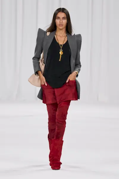 A woman wears tassel accented necklace on the balmain s/s 25 runway.