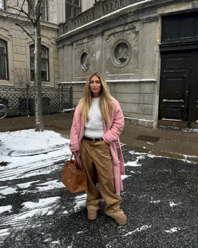 Woman wearing baggy brown corduroy pants.