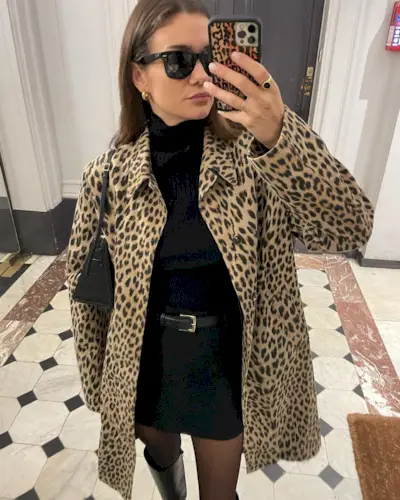 @annelauremais wears a leopard print coat and black dress outfit