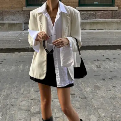 woman wearing white button-down shirt and black mini skirt summer 2025