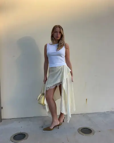 woman wearing asymmetrical skirt and white tank summer 2025