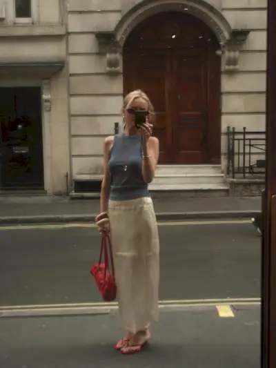 woman wearing long cord necklace with tank and skirt summer 2025