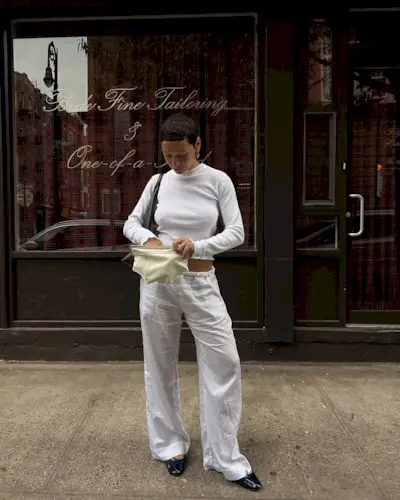 woman wearing cotton pointelle top and white linen pants summer 2025