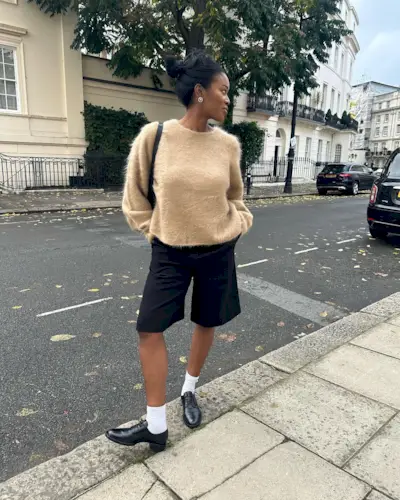 Influencer wears socks with lace up shoes.