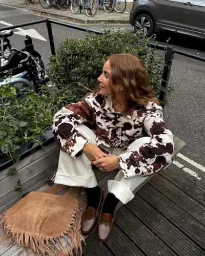 Influencer wears loafers with black socks.