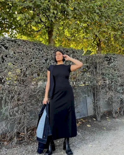 @isabellecoheen wearing a black dress and boots