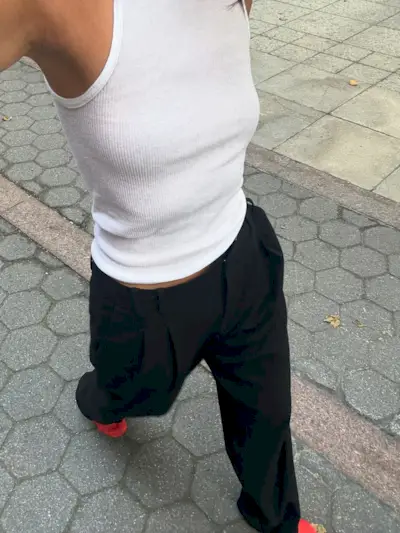 @mimixn wears red mesh flats with black trousers and a white tank top