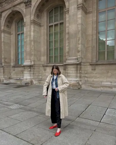 @ruerodier wears red mesh flats with black trousers, a white tee, denim shirt and beige trench coat