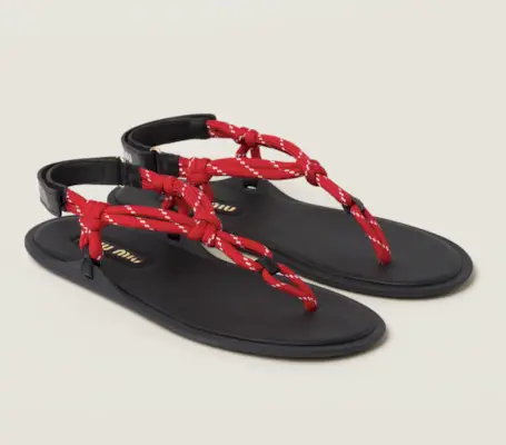 Influencer Mariana wears a white baby doll dress wears red flip flops and a red handled whicker bag